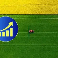 Wykres wzrostu na tle pola rzepaku i zielonej łąki, gdzie pracuje traktor. Zastanawiasz się, ile kosztuje hektar ziemi?